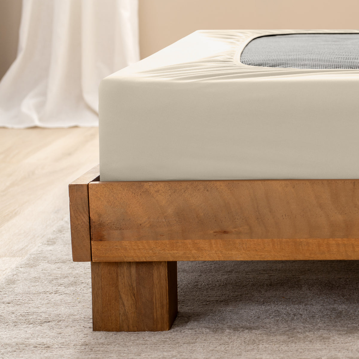 Close up of the corner of a bed frame with a cover box spring 