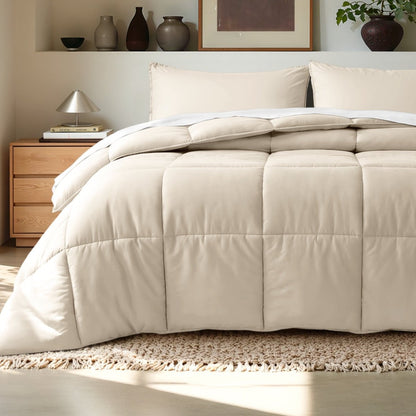 Comforter on a bed in a bedroom setting with a wooden nightstand and decorative items.
