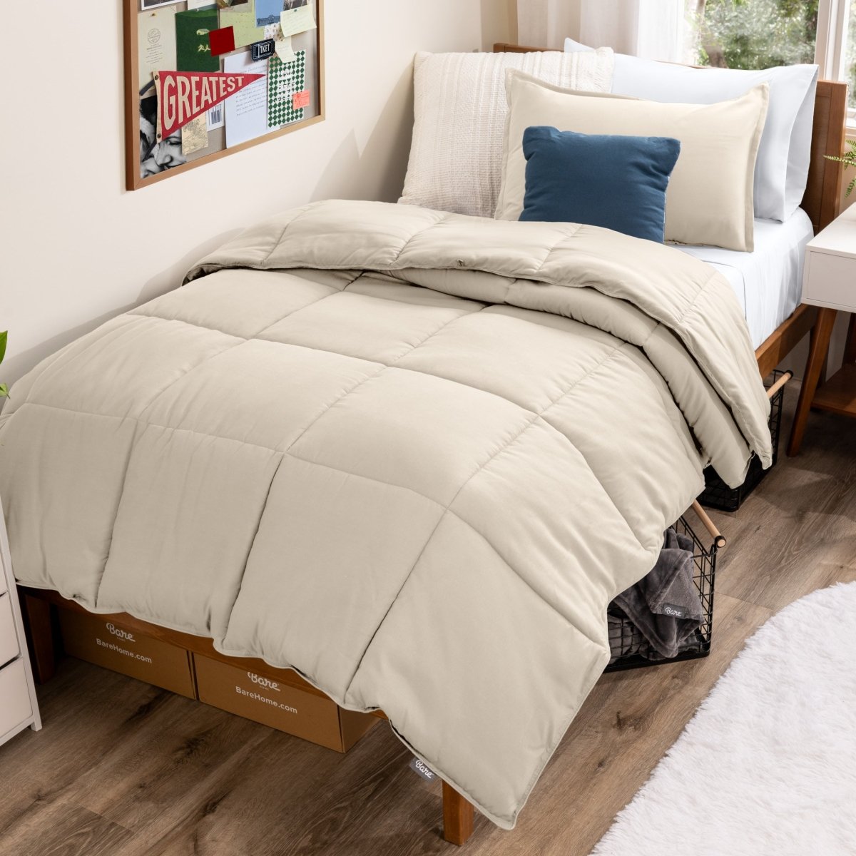 Bed with comforter and pillows in a dorm room