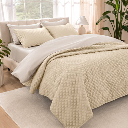 Bedroom showing coverlet set laying on the bed with the quilt folded over on itself