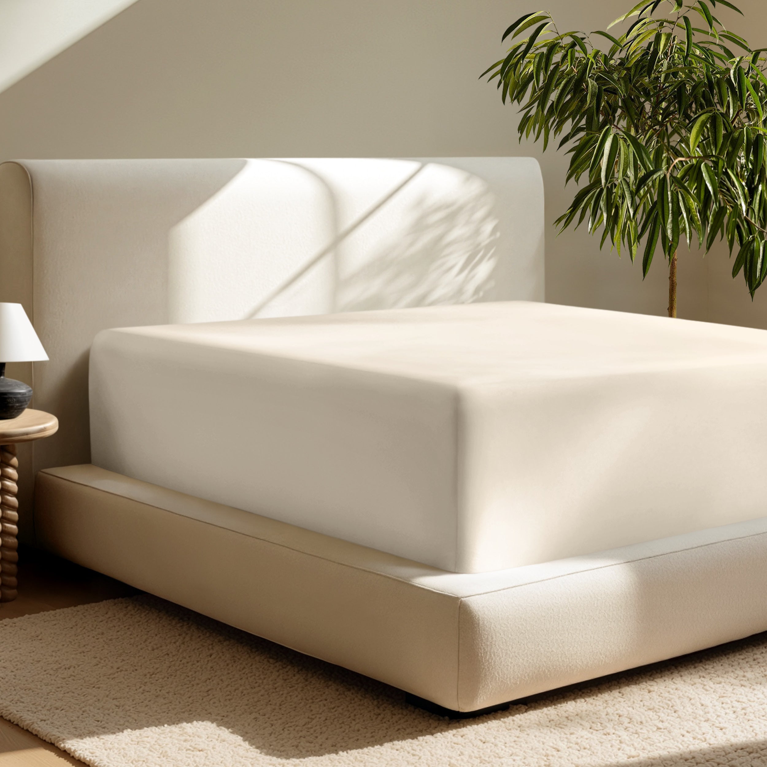 A deep pocket fitted sheet on a mattress