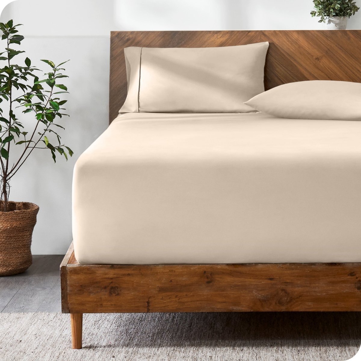 Wooden bed with ultra soft bedding in a minimalistic room.
