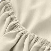 Close up of a microfiber fitted sheet showing the elastic