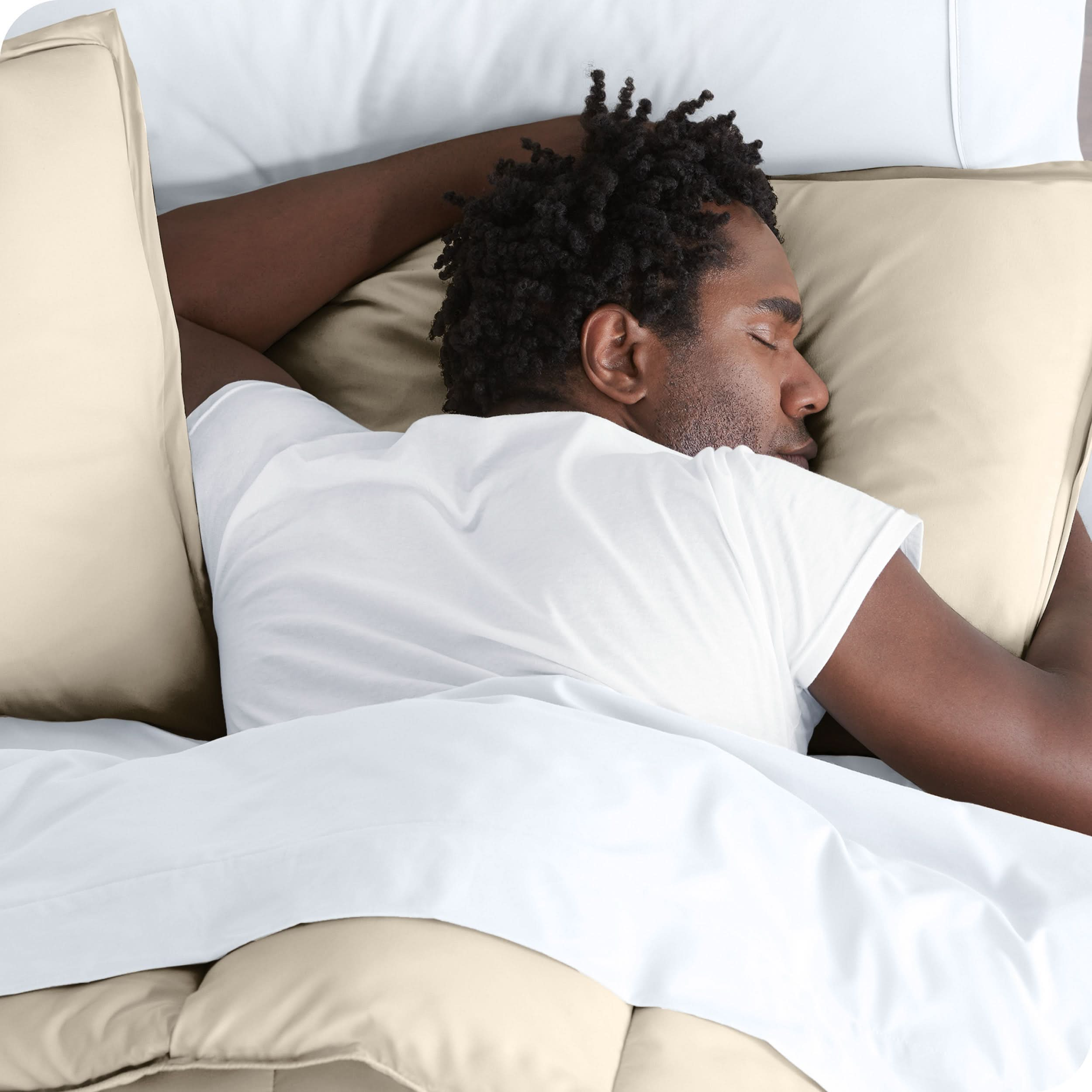 Man sleeping with his head resting on a pillow sham