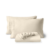 Pillowcases and a matching fitted sheet folded in front, shown on a plain white background.