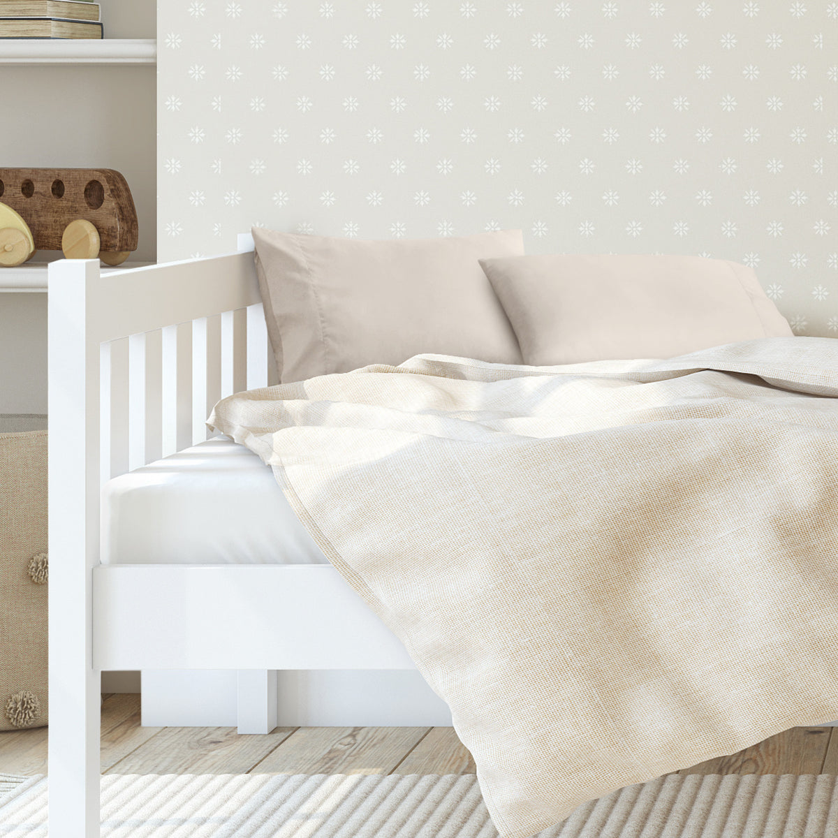 A toddler's bed with 2 microfiber pillowcases on pillows