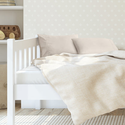A toddler's bed with 2 microfiber pillowcases on pillows