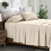 A cozy bedroom featuring a neatly made bed with soft, microfiber sheets.