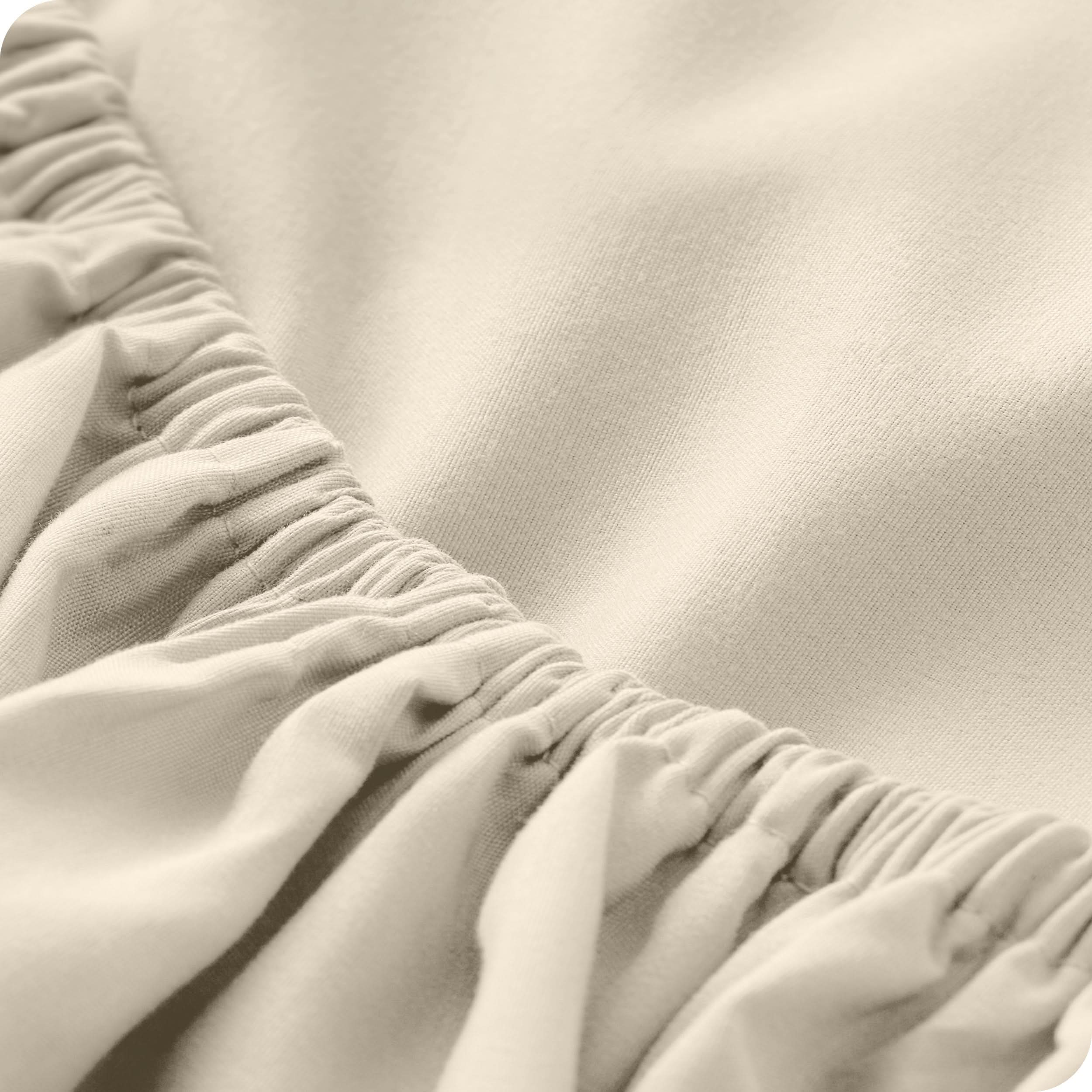 A close-up of a fitted sheet showcasing its elastic edge