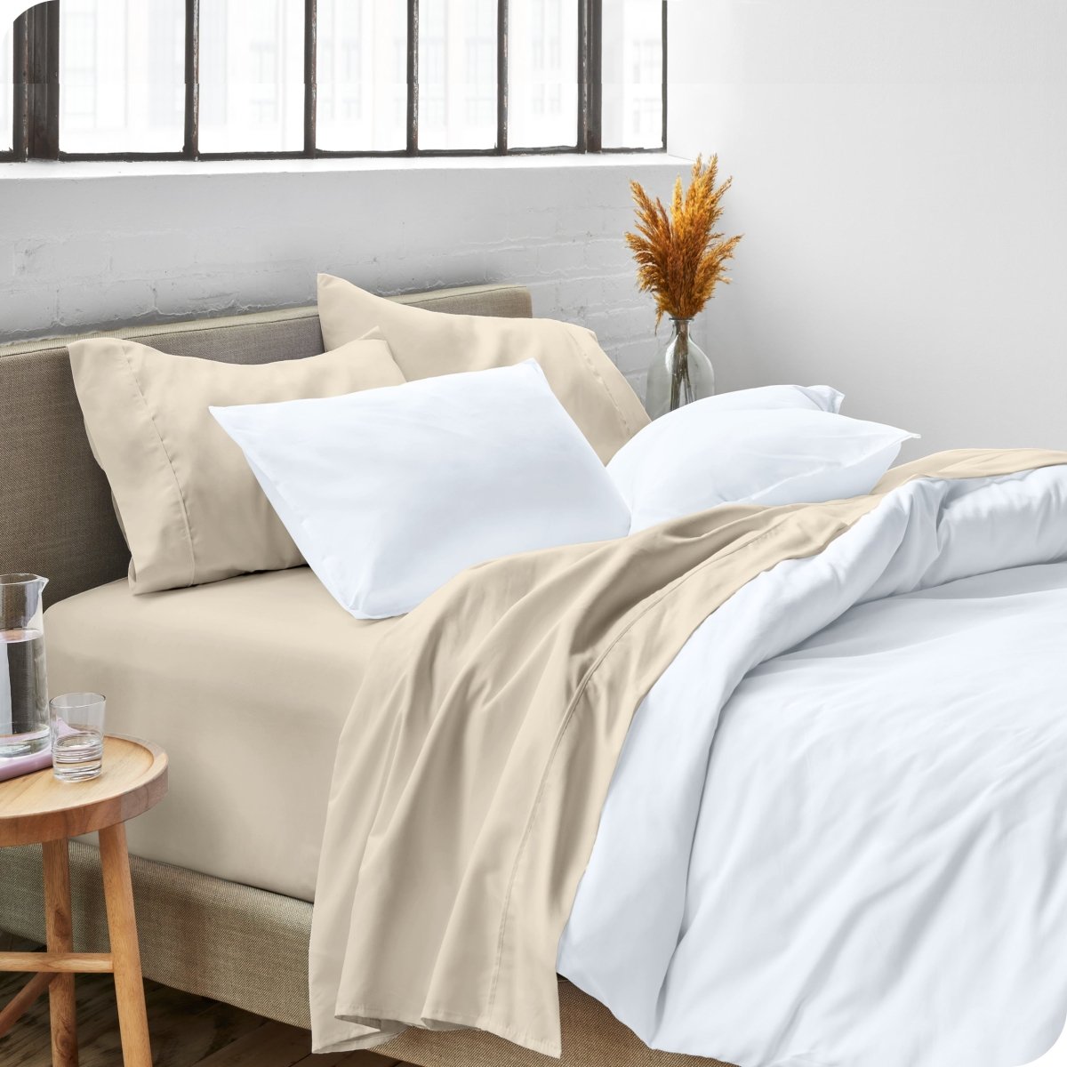 A side view of a bed made with microfiber sheets and a white duvet cover
