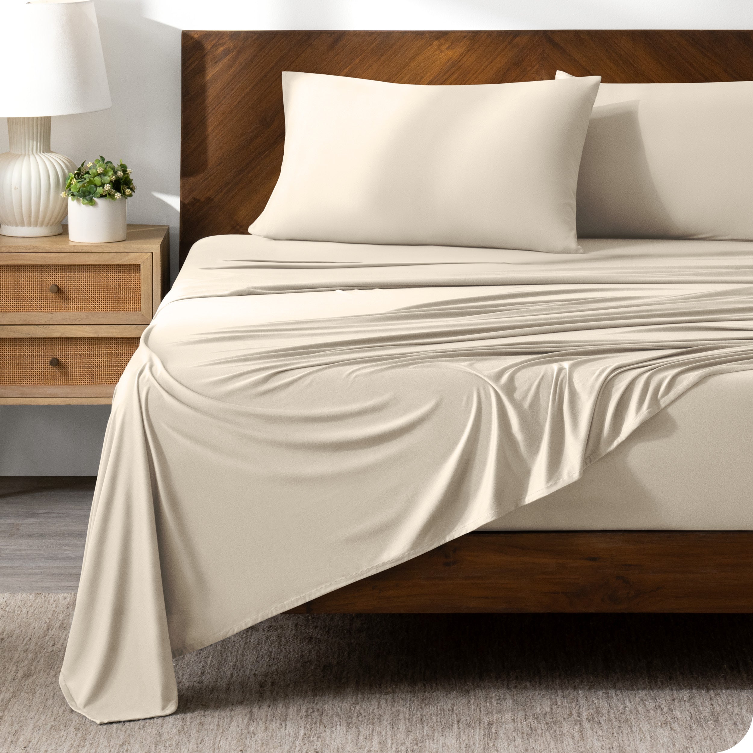 Sand sheet set on a bed with a dark wooden bed frame