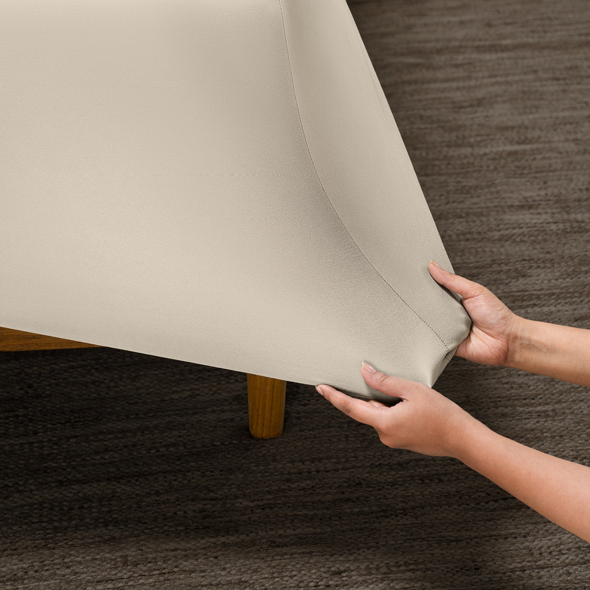 Person putting a microfiber stretch fitted sheet on a mattress