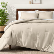 Bedding set on a bed in a bedroom with a side table and lamp.
