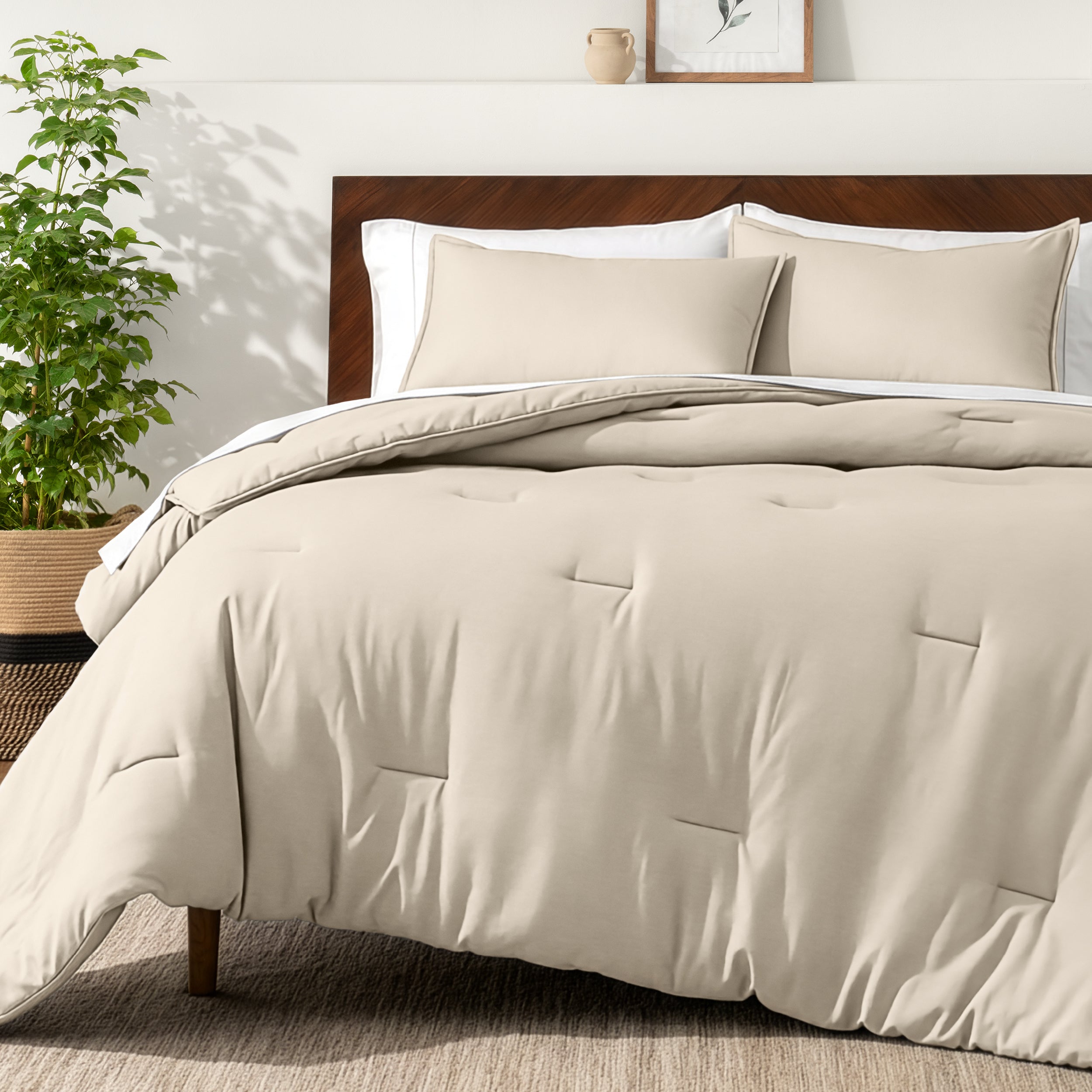 Bedding set on a bed in a bedroom with a side table and lamp.