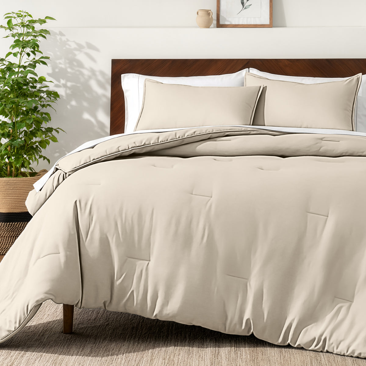 Bedding set on a bed in a bedroom with a side table and lamp.