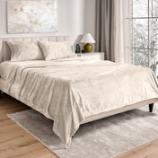 Neatly made bed in a well-lit bedroom.