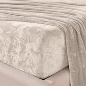 Close-up of the corner of a bed made with microplush sheets