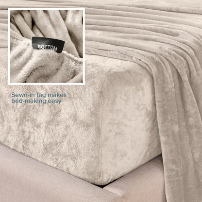 Close-up of the corner of a bed made with microplush sheets