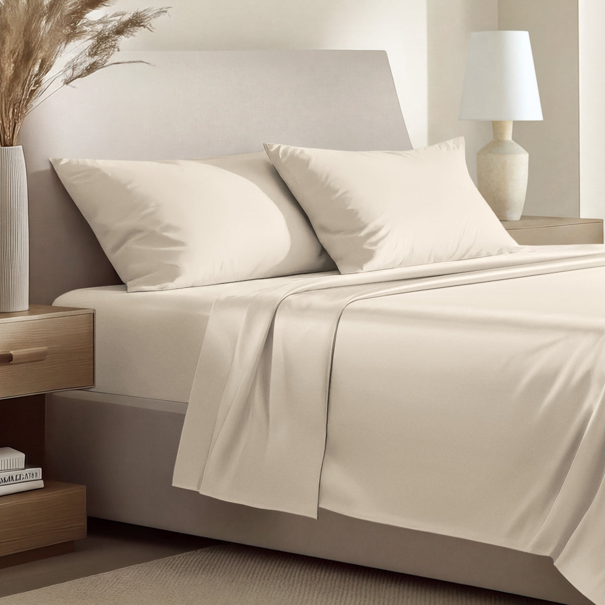 Sateen bedding set including a fitted sheet and two matching pillowcases on a bed.