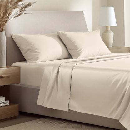 Sateen bedding set including a fitted sheet and two matching pillowcases on a bed.