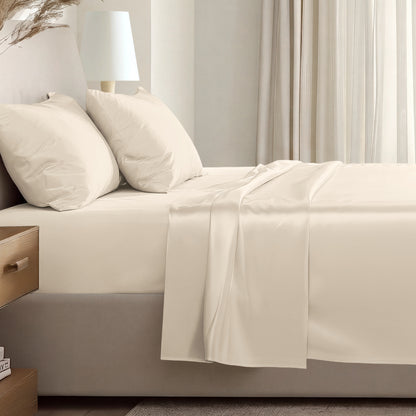 Sateen sheet set on a bed in a softly lit bedroom.