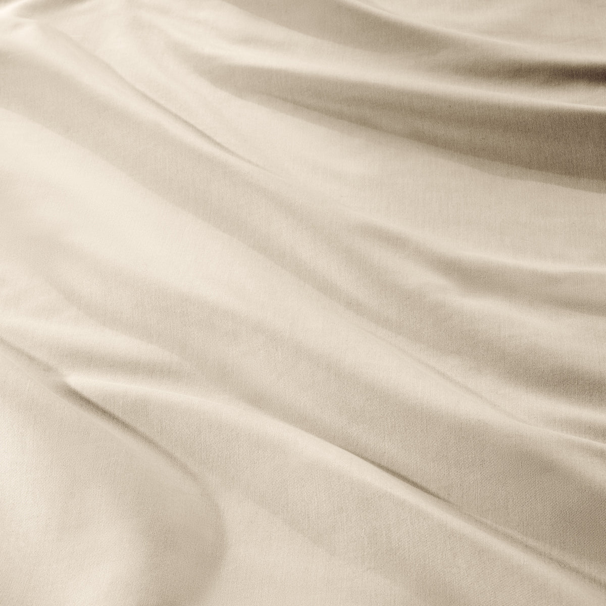 A close-up of draped sateen fabric with soft folds and a smooth texture.
