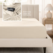 Bed with a fitted sheet next to a nightstand in a bedroom setting