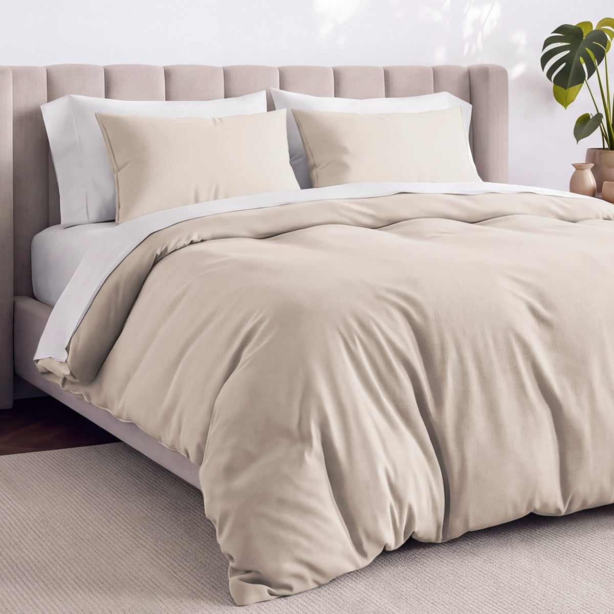 Bed with jersey duvet set against a beige headboard.