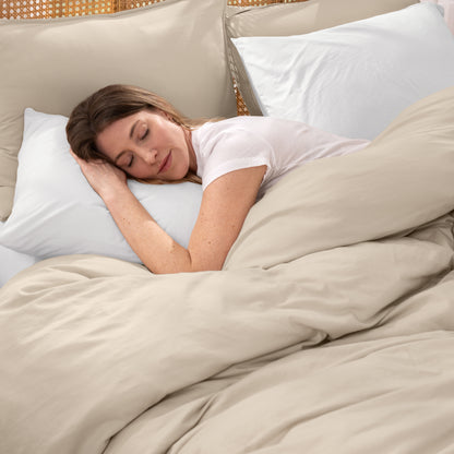 Woman sleeping peacefully under organic jersey bedding