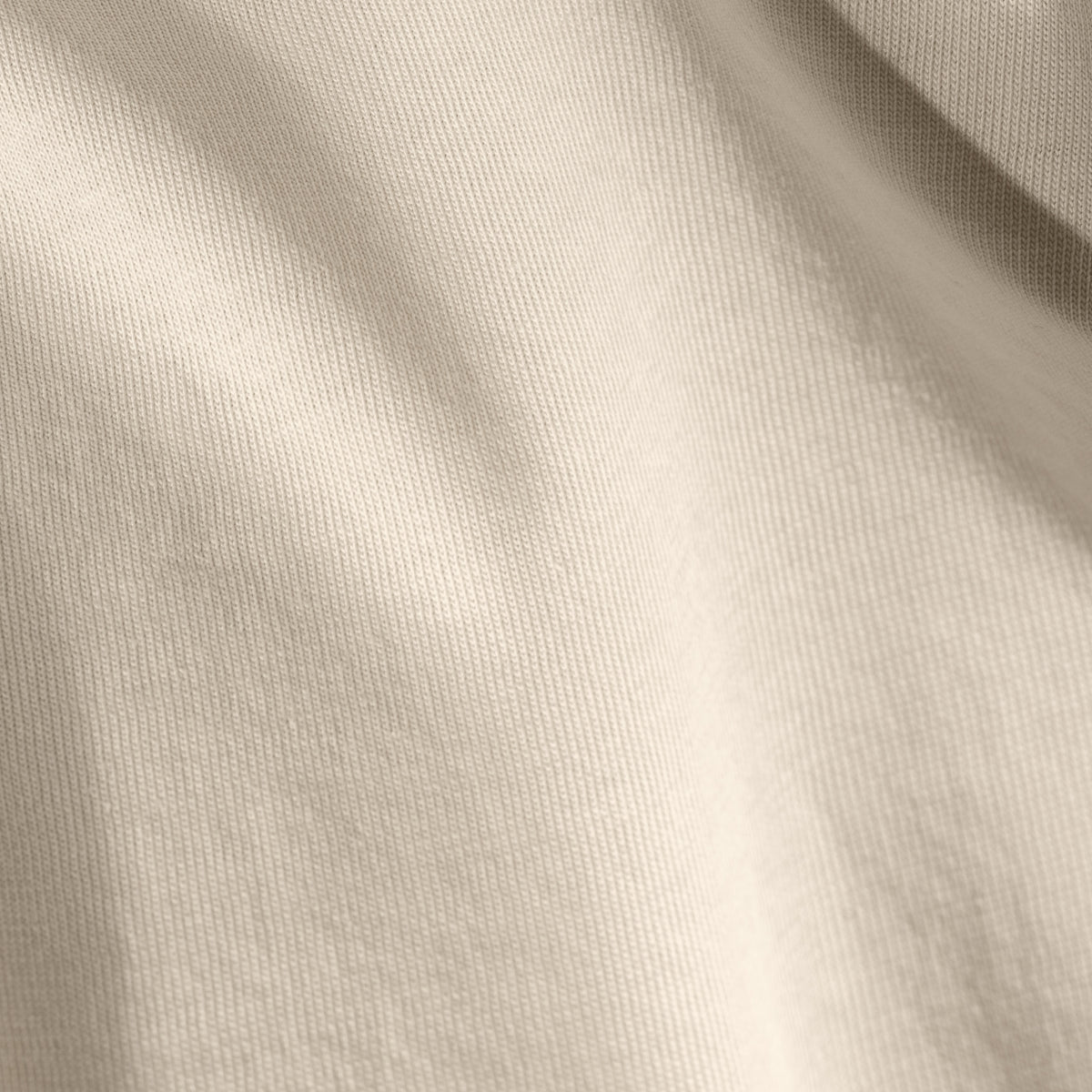Close-up of organic cotton jersey fabric with subtle texture