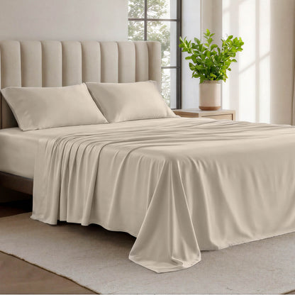 Organic cotton jersey sheets on a bed with a wicker headboard in a room with plants and a lamp.
