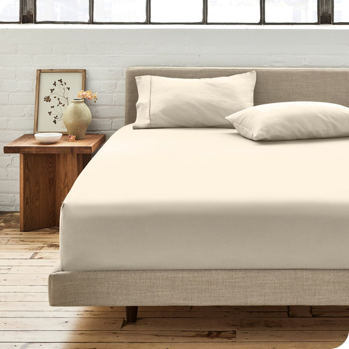 Modern bedroom with bed showing percale fitted sheet