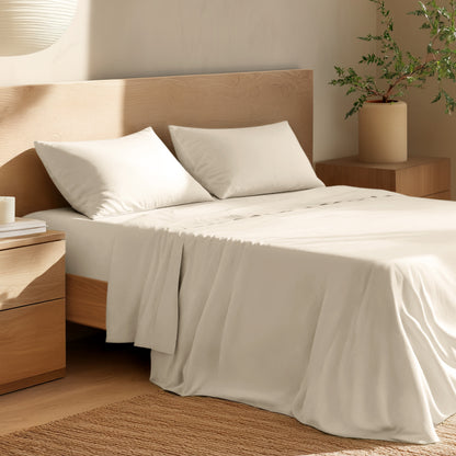 Bed with percale bedding and wooden headboard in a bedroom setting