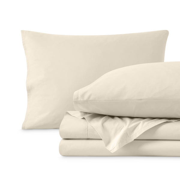 Percale sheets folded and matching pillowcases with pillows in them
