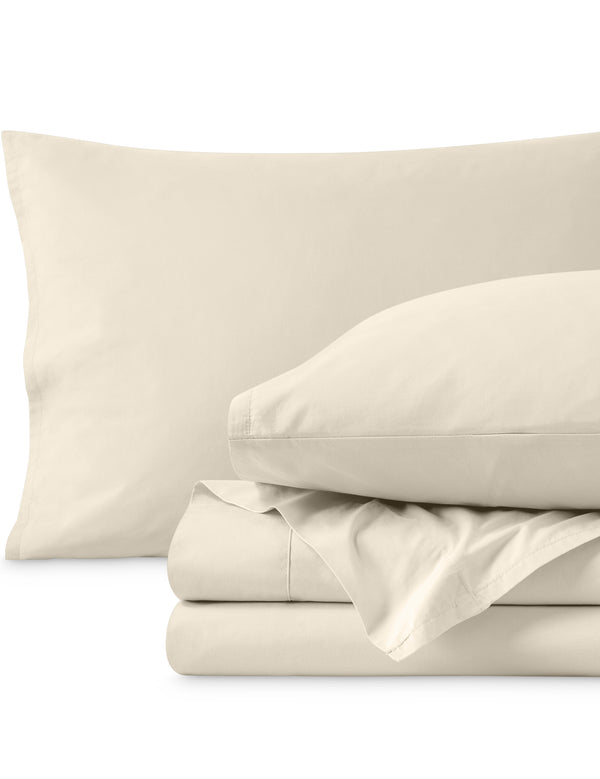Percale sheets folded and matching pillowcases with pillows in them