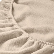 A close view of the elastic of a polar fleece fitted sheet.