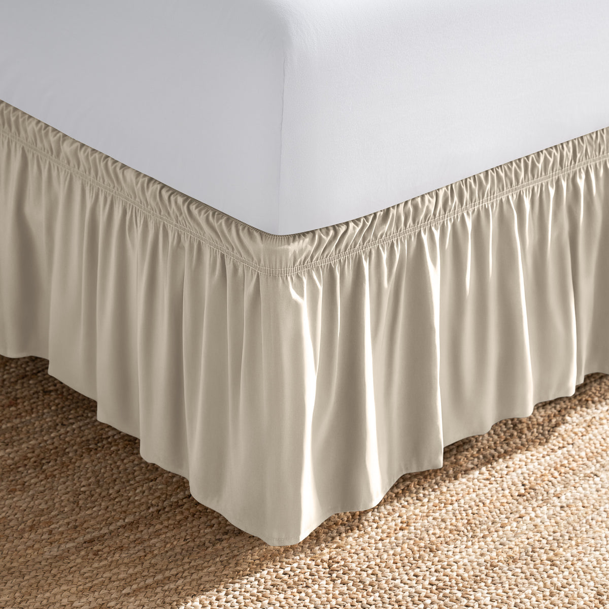 Bed with white fitted sheet and an adjustable bed skirt.