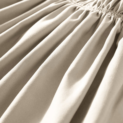 Close-up of polyester bed skirt fabric with a focus on texture and folds.