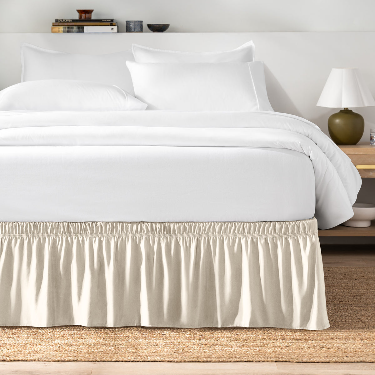 Bed with white bedding and a bed skirt.