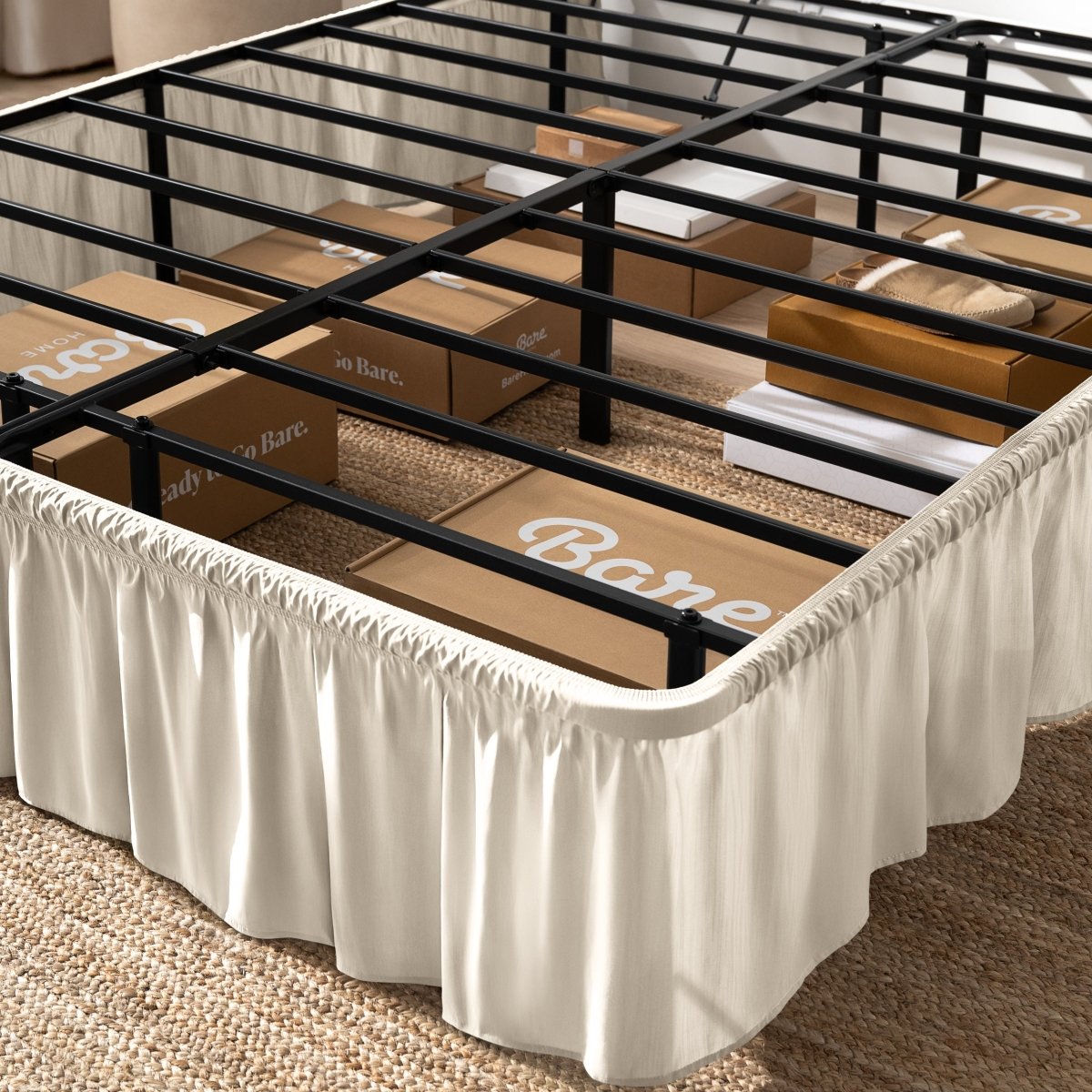 Bed frame with bed skirt and Bare Home boxes underneath.