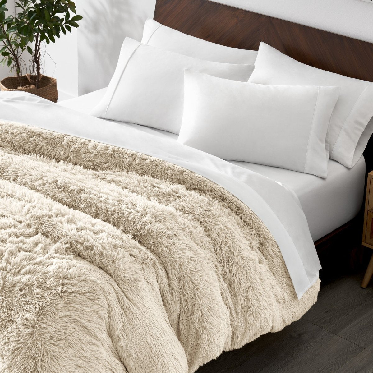 Shaggy duvet cover on a bed with white pillows and a wooden headboard.