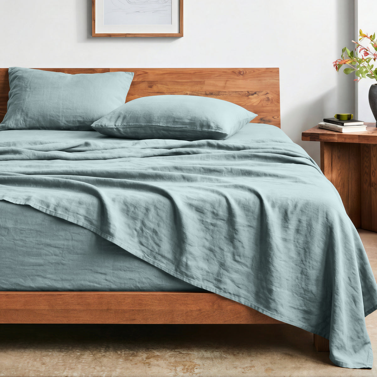 Bed with washed sheets and wooden headboard in a bedroom setting