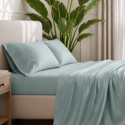 Ultra-soft sheets and pillowcases on a bed with a plant in the background
