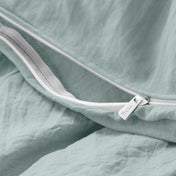 Close-up of a duvet cover with a zipper, featuring the brand Bare Home