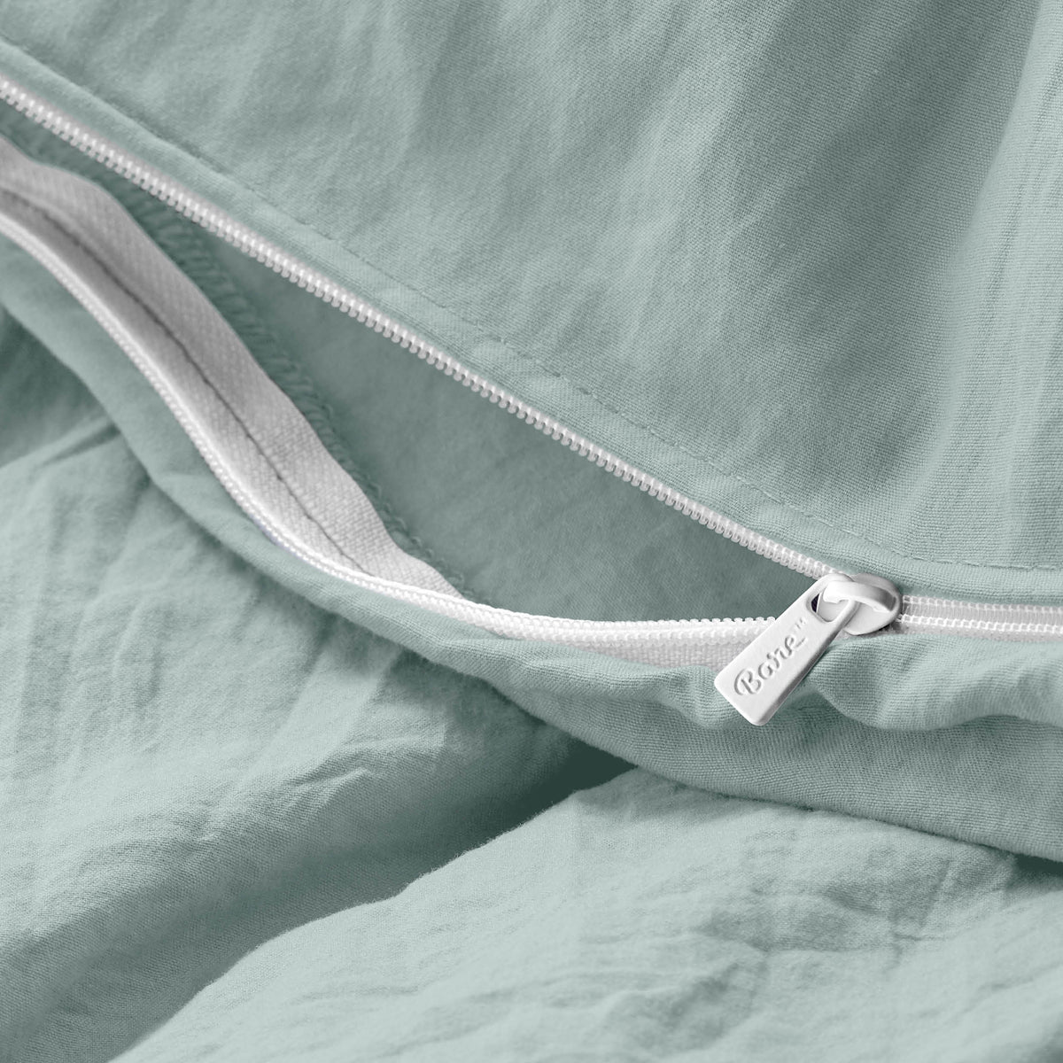Close-up of a duvet cover with a zipper, featuring the brand Bare Home