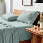 Bed with microfiber bedding and pillows in a bedroom setting