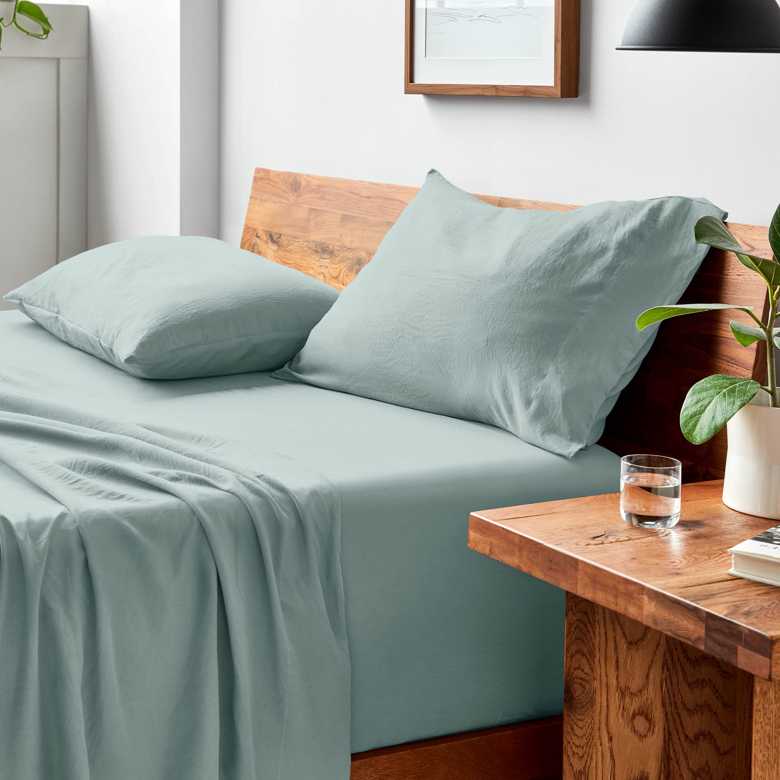 Bed with microfiber bedding and pillows in a bedroom setting