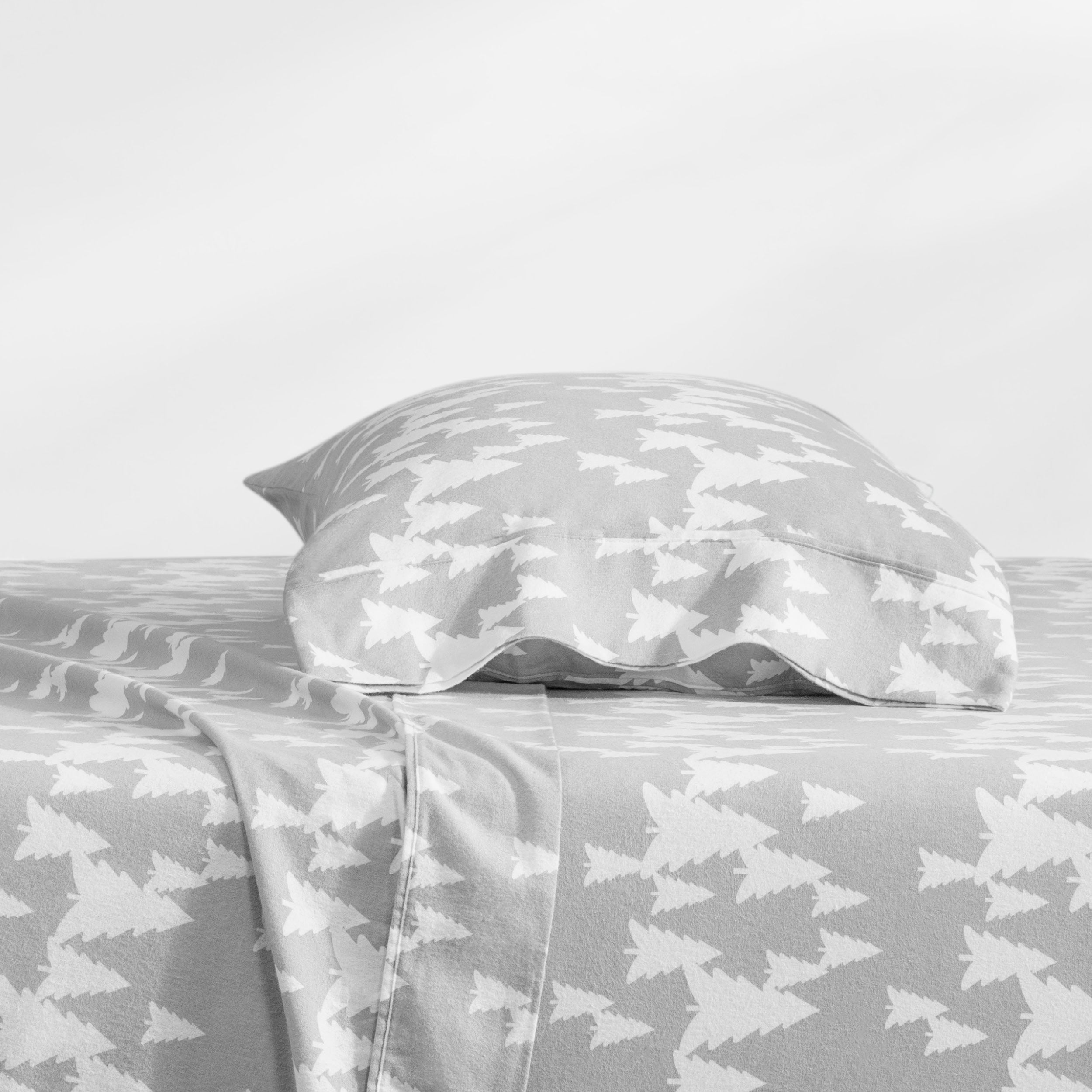 A gray and white patterned bed sheet set with a matching pillowcase