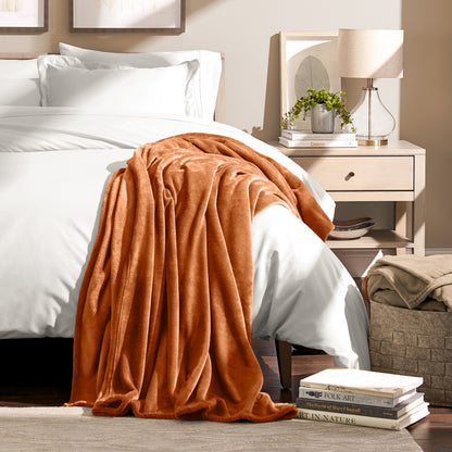Microplush blanket draped over the corner of a bed