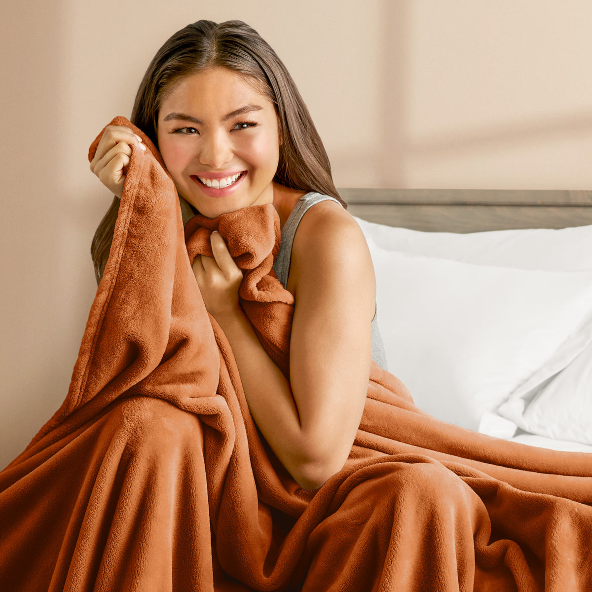 A woman cuddling with a microplush blanket